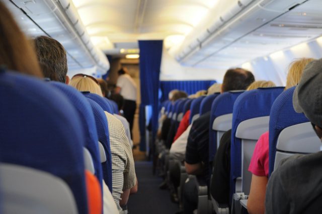 5 Yoga Poses To Help You Stretch Out In an Airplane Seat